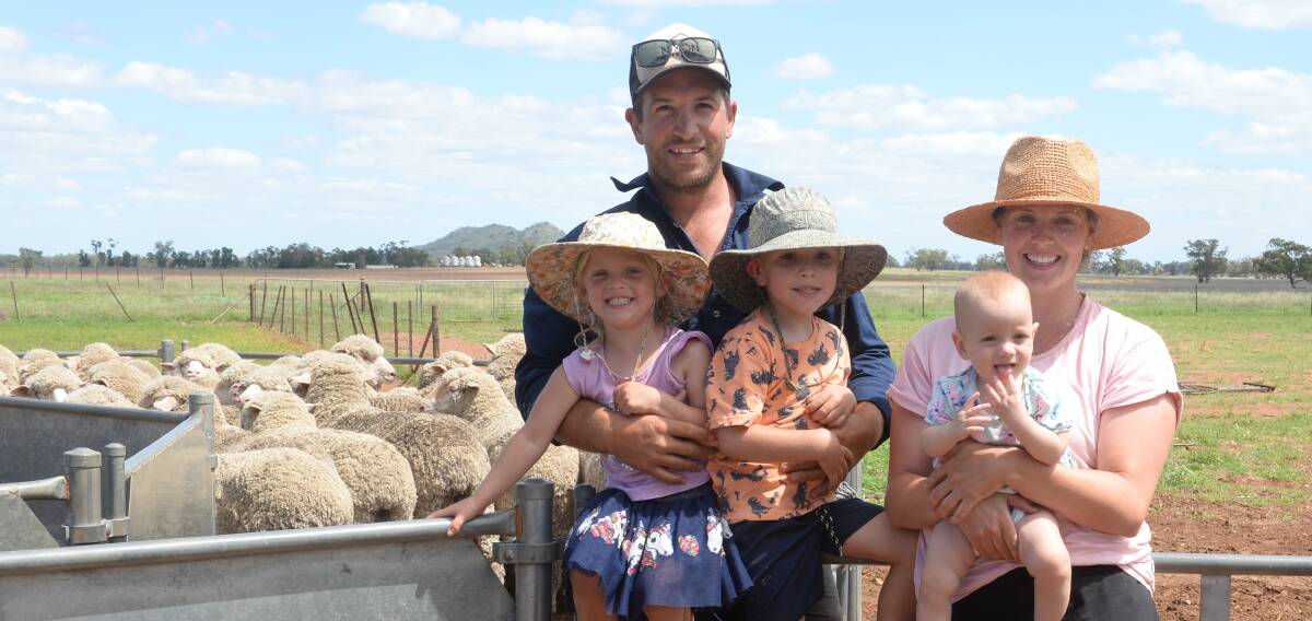 James and Elise Nixon, Leewan, Yarrabandai, with their children, Maggie, Henry and Elkie, with their champion maiden Merino ewes.