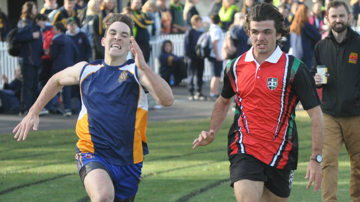 COME BACK HERE: Pat Halsey and Brock Larance go stride-for-stride during the athletics last year. Photo: NICK McGRATH