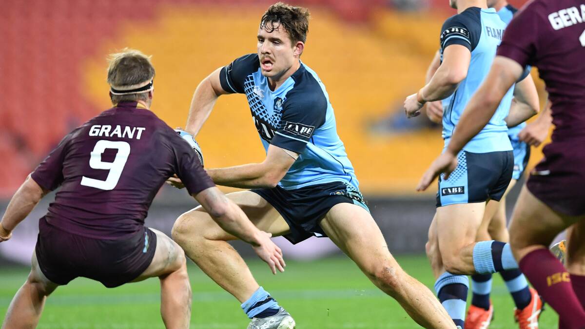 UP THE GUTS: Billy Burns takes the ball forward at Suncorp Stadium on Wednesday night, but the Blues dropped the Darren Lockyer Shield to the Maroons. Photo: NRL PHOTOS