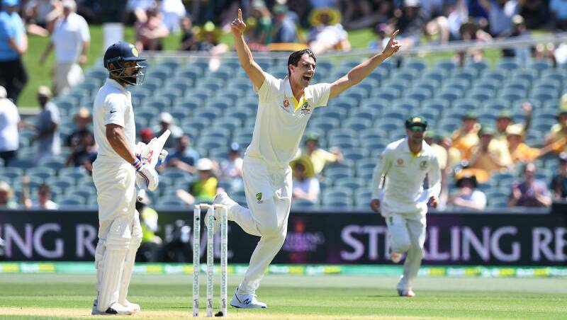 Australian bowler Pat Cummins reacts after dismissing Indian batsman Virat Kohli (left) for three runs. Photo: AP