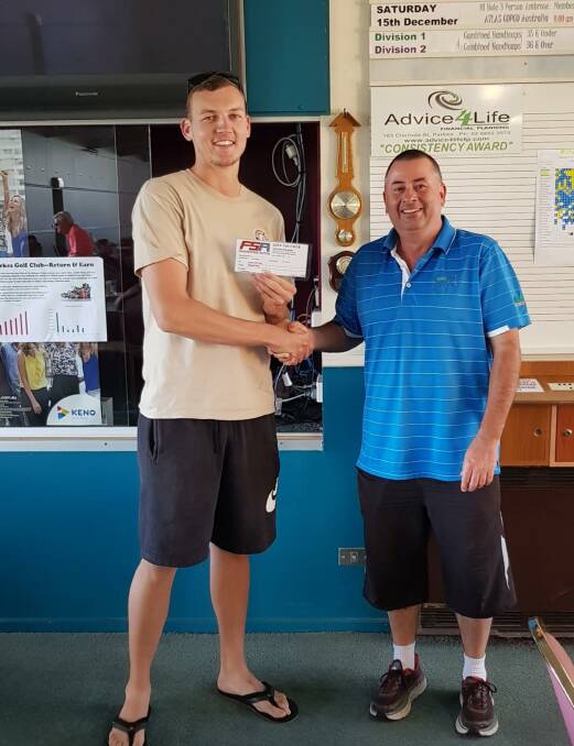 Josh Cheney collects Saturday's prize from Parkes Golf Club's John Green.