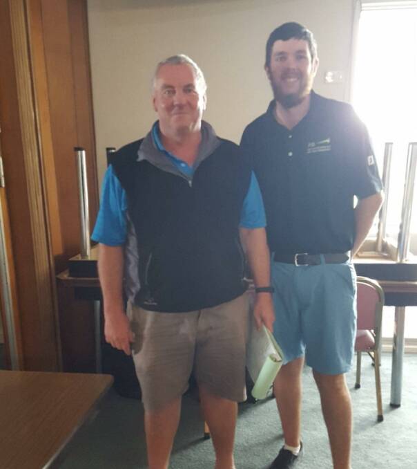 Parkes Golf Club captain Peter Dixon congratulates Brad Scott on his victory last Saturday.