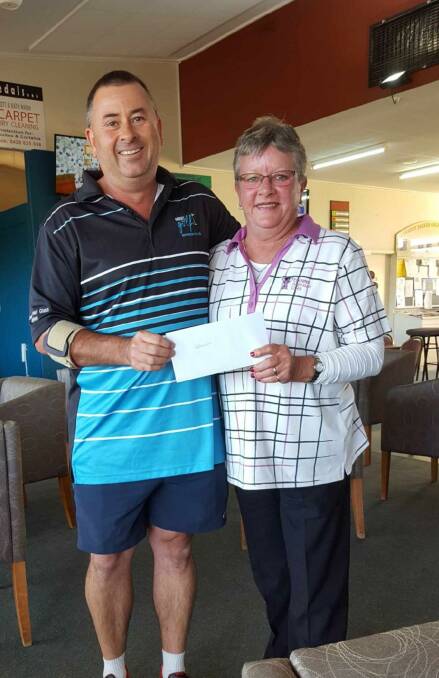 Parkes Golf Club's John Green presents Saturday's winner Cath Kelly with her prize.