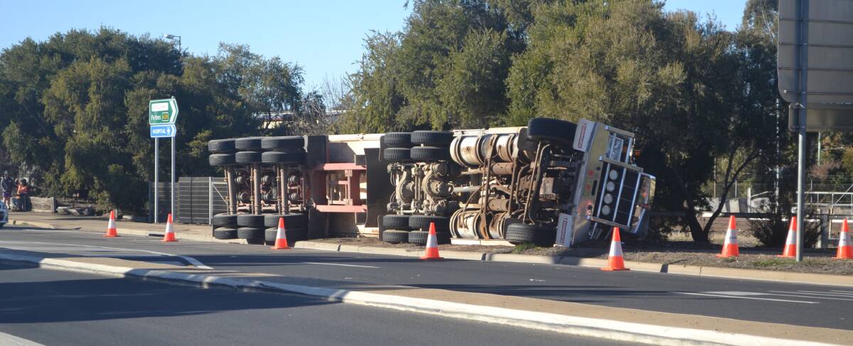 A truck has rolled onto it's side on the Newell Highway near the Forbes Road intersection. Photos: Denis Howard.