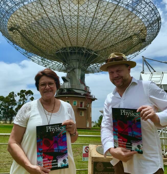 Writer Kerrie Peden and Sean James Cassidy holding copies of Australian Physics magazine, with Sean's artwork on the front.