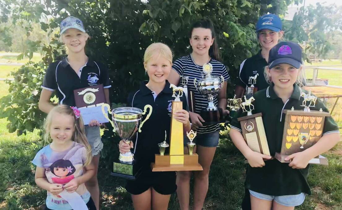 Sophia Burns, Taylah Mapperson and Ruby Moore, front is Tori Bennett, Lara Bennett and Lucy Chapman with their awards at Parkes Pony Club.