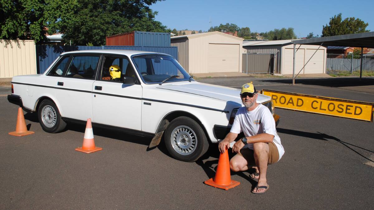 Ian Rowe with his wife Bev Rowe's pride and joy. No that's not Bev behind the wheel, it's a crash test dummy.