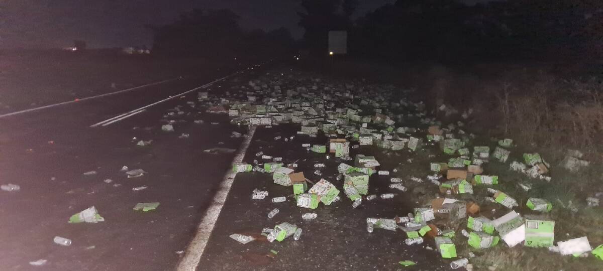 CLEAN-UP: It is understood the truck driver swerved to avoid hitting a kangaroo, which caused the alcohol to fall from the truck. Photo: Submitted