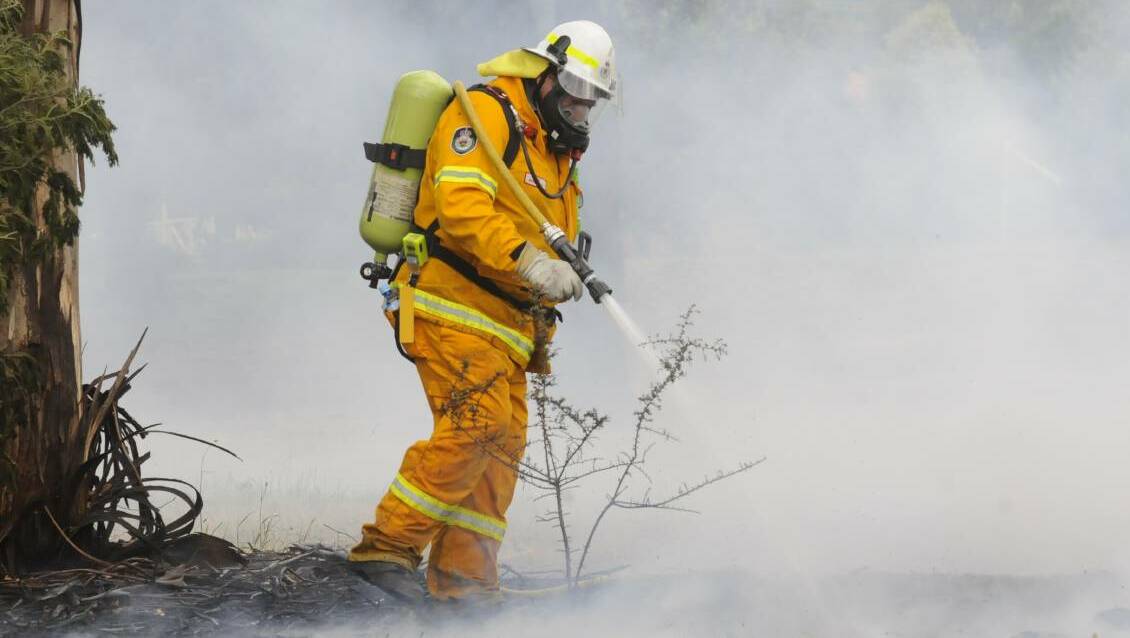BURN: A NSWRFS officer surveys the scene at a Raglan fire in recent years. A number of hazard reduction burns are scheduled to take place in the Central West soon. Photo: CHRIS SEABROOK