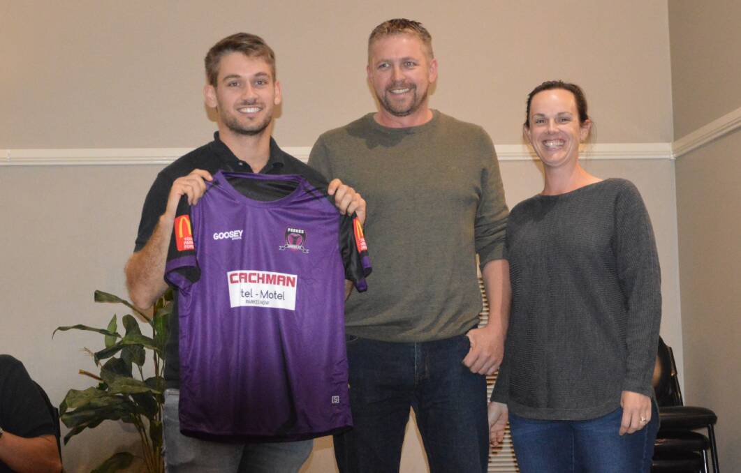 PURPLE PEOPLE EATER: Cobras' ace Hayden Westcott shows off Parkes' new kit, after being presented it by Michelle and Richard Bligh from Choices Flooring. Photo: KRISTY WILLIAMS
