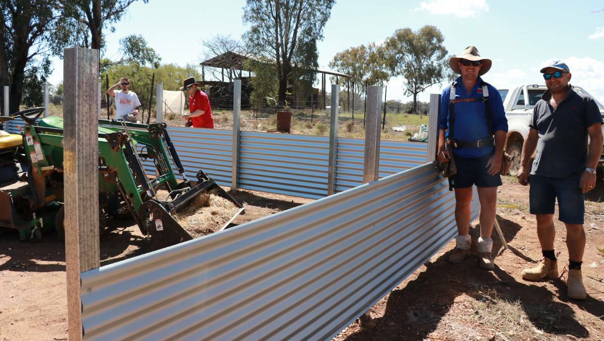 Builders Ben Wiseman (Dubbo) and Enzo Crino (Sydney) were happy to lend their skills to someone in need when Rural Aid brought its Mega Farm Rescue and band of volunteers to Forbes last October. Photo: Supplied 