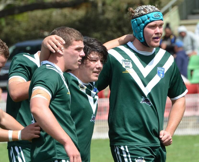 STICKING TOGETHER: Parkes' Finnley Neilsen and Forbes' Jack Hartwig (centre) during the Rams' fourth group game in Blayney. Hartwig is 'disappointed' he won't be able to take part in the Laurie Daley Cup finals.