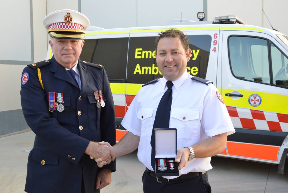 RECOGNISED: Inspector Peter Rowlands (left, pictured with Parkes paramedic Daniel Wright in 2017) has received an Ambulance Service Medal. Photo: Barbara Reeves