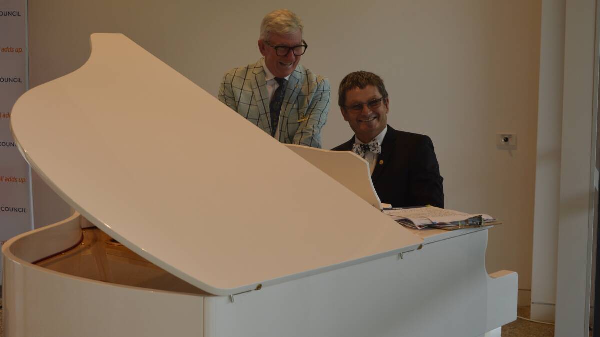 PLEASING THE CROWD: Musical stars Cr Bill Jayet and Cr Neil Westcott tickling the ivories on the new electronic baby grand piano, which is currently residing in the pavilion. Photo: KRISTY WILLIAMS.
