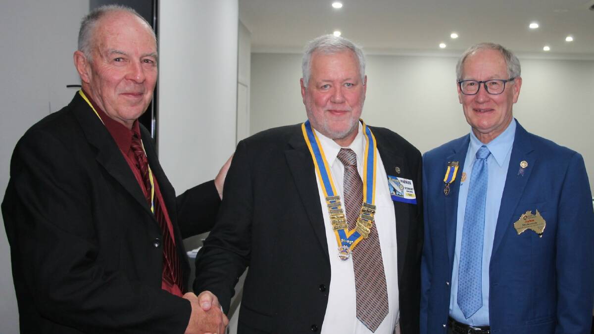 ROTARY CLUB ANNUAL CHANGEOVER: Mark Ritchie hands over to new president Robert Shore with John McKenzie. Photo: Supplied.