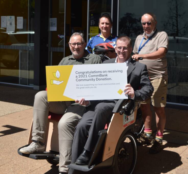GOLDEN DAYS: Cycling Without Age in Parkes receives a donation from the local branch of the Commonwealth Bank to go towards new helmets. Photo: KRISTY WILLIAMS.