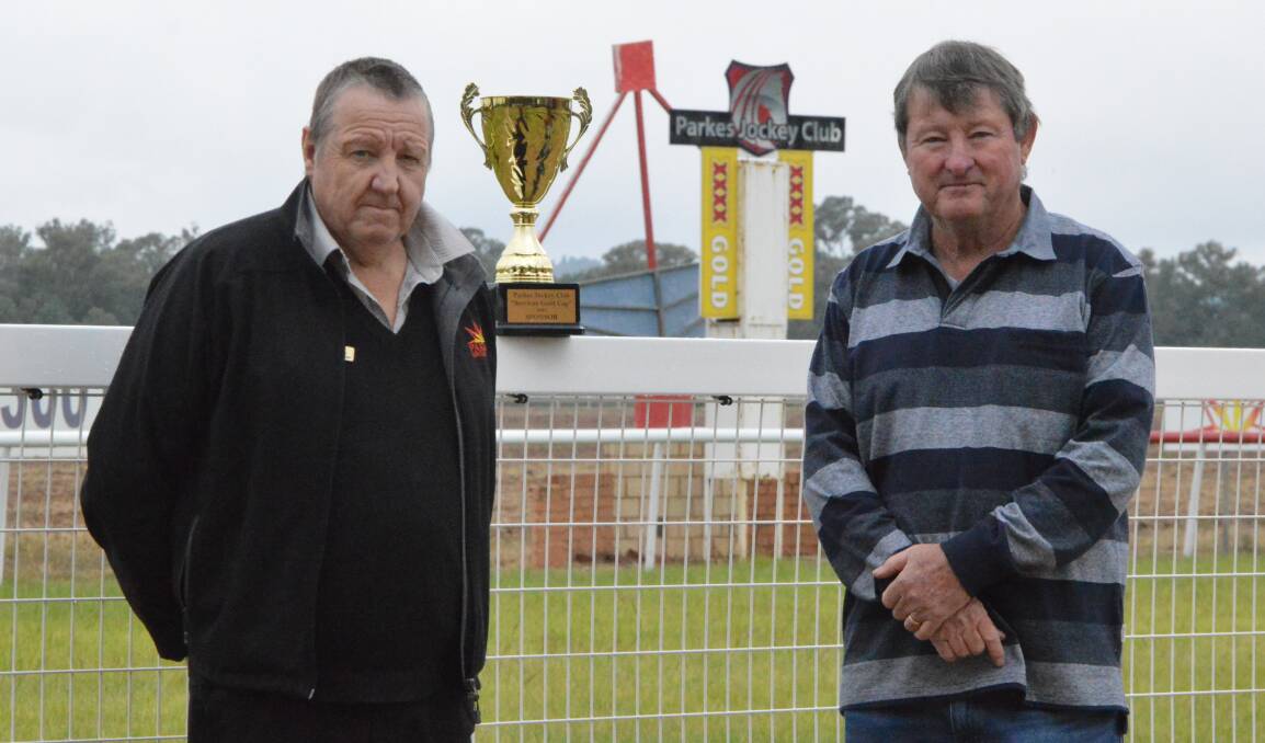 ALMOST TIME FOR THE CUP: Parkes Services Club general manager Mike Phillips and Mark Ross, president of the Parkes Jockey Club with the Gold Cup. Parkes Services are sponsoring the event. Photo: Kristy Williams.