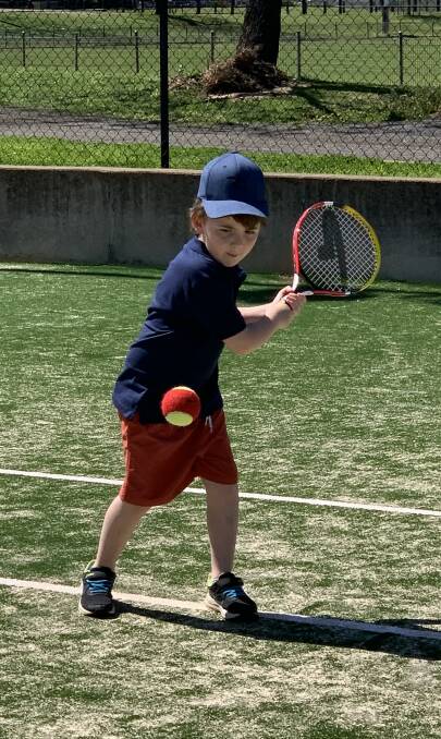 FOCUSED: Myles Baker is full of concentration as he has a hit at the Parkes Tennis Centre. Photo: SUPPLIED.