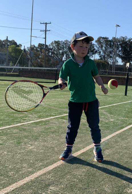 SPRING WITH A SIDE SERVE OF TENNIS: Budding ace Ned Magill is loving his HotShots at the Parkes Tennis Centre. Photo: SUPPLIED.
