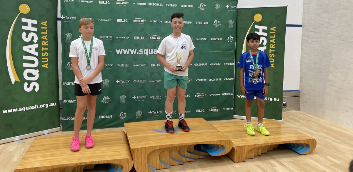 RISING STAR: Parkes player Henry Kross (centre) as taken out the under 11's title in the Australian Junior Squash Championships.