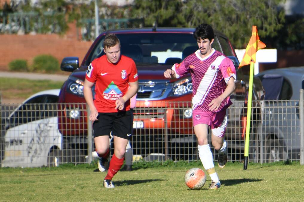 DRIBBLE DRIBBLE: Alec Bateson runs with the ball for Parkes in the game against Panorama FC. Photo: Jenny Kingham.