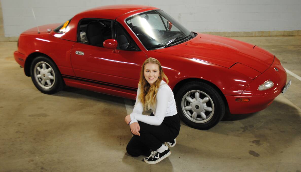 WHAT A BEAUTY: Abagail Sharples is the proud owner of a 1989 Mazda MX-5 - which also called a Miata. She's keen to drive it in the Elvis parade next year. Photo: Supplied.