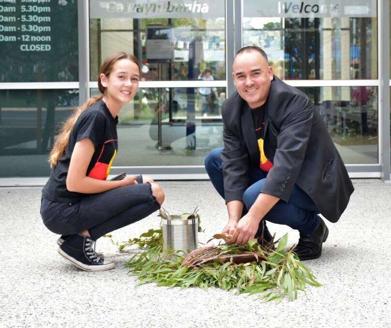 Acknowledging the traditional custodians: Keira and Kevin Bloomfield prepare the Smoking Ceremony at the front of the Library space. Photos: Jenny Kingham.