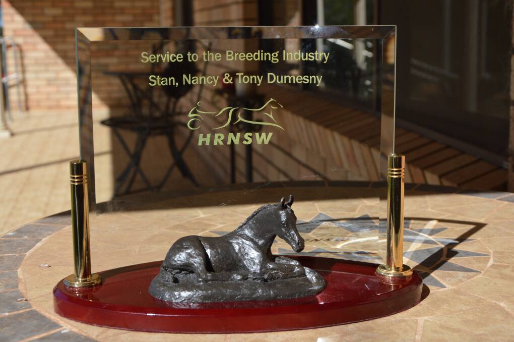 WHAT AN HONOUR: The stunning trophy that Tony, Stan and Nancy received from Harness Racing NSW.