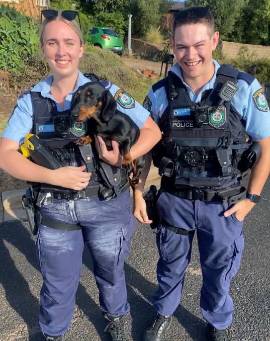 HEROES: Two Parkes police officers with one of the rescued canines from the Glenwarrie Place fire. Photo: Central West Police District.