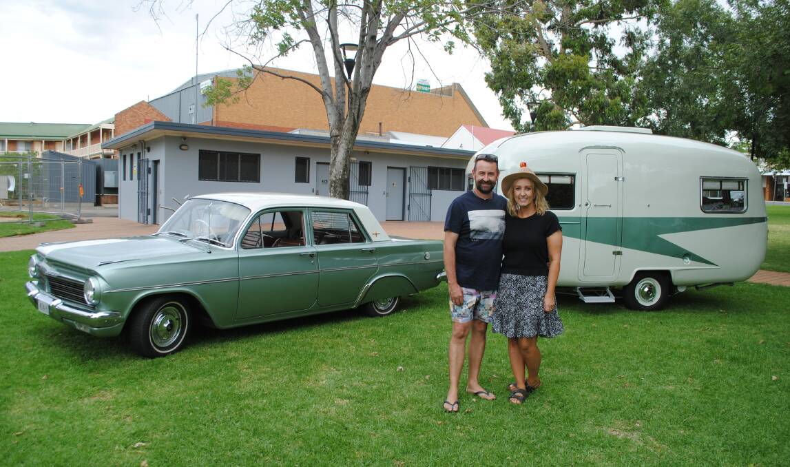 PROUD AS PUNCH: Laura and Michael O'Shannessy with their 1963 Sunliner caravan at the Central West Car Club's showing at Cooke Park in Parkes on Australia Day. Photo: Supplied.