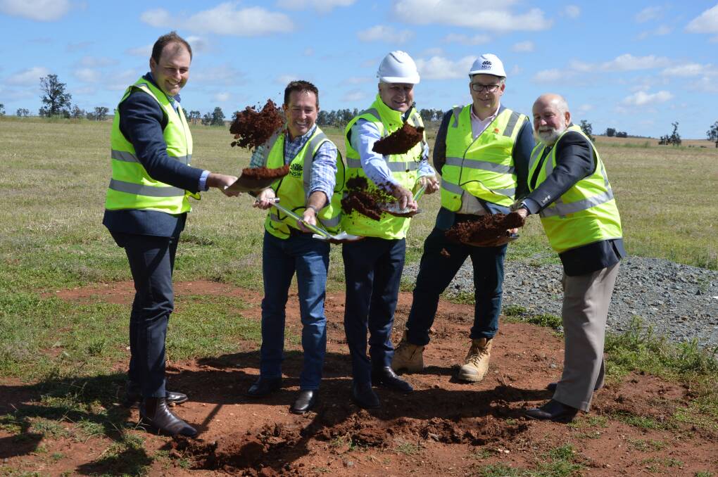 MOMENTOUS DAY FOR PARKES: Sam Farraway, Paul Toole, Michael McCormack, Alistair Lunn and Ken Keith turn the first sod on the Newell Highway Bypass in Parkes. Photo: KRISTY WILLIAMS.