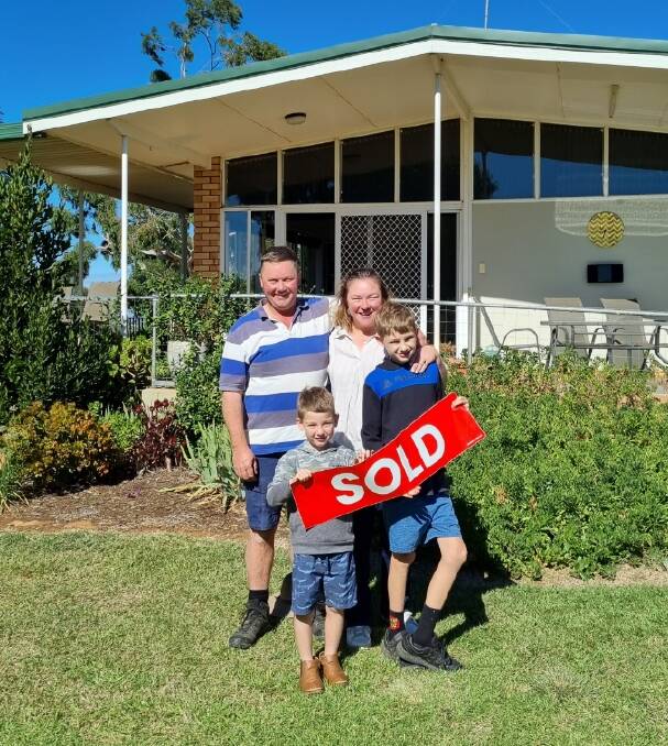The happy buyers, Eric and Alice Milne and their two sons.