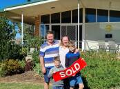 The happy buyers, Eric and Alice Milne and their two sons.