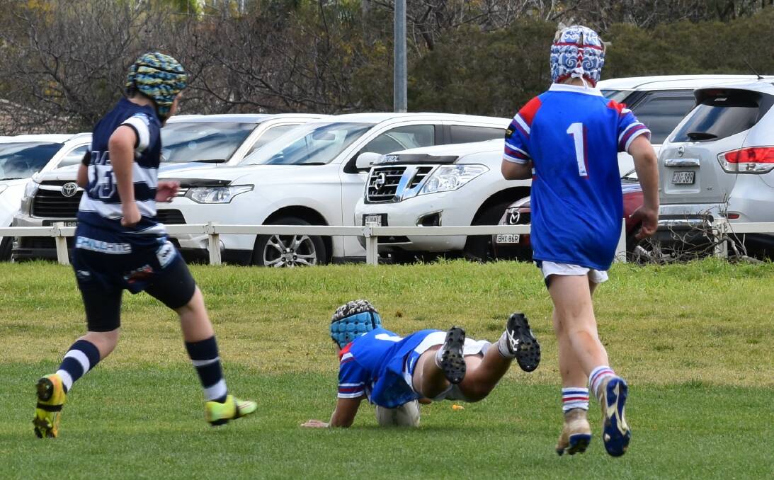 DIVES OVER: Jaylin Moran scores a try for the under 12 Blues against the Dubbo Raiders. Photo: Supplied. 