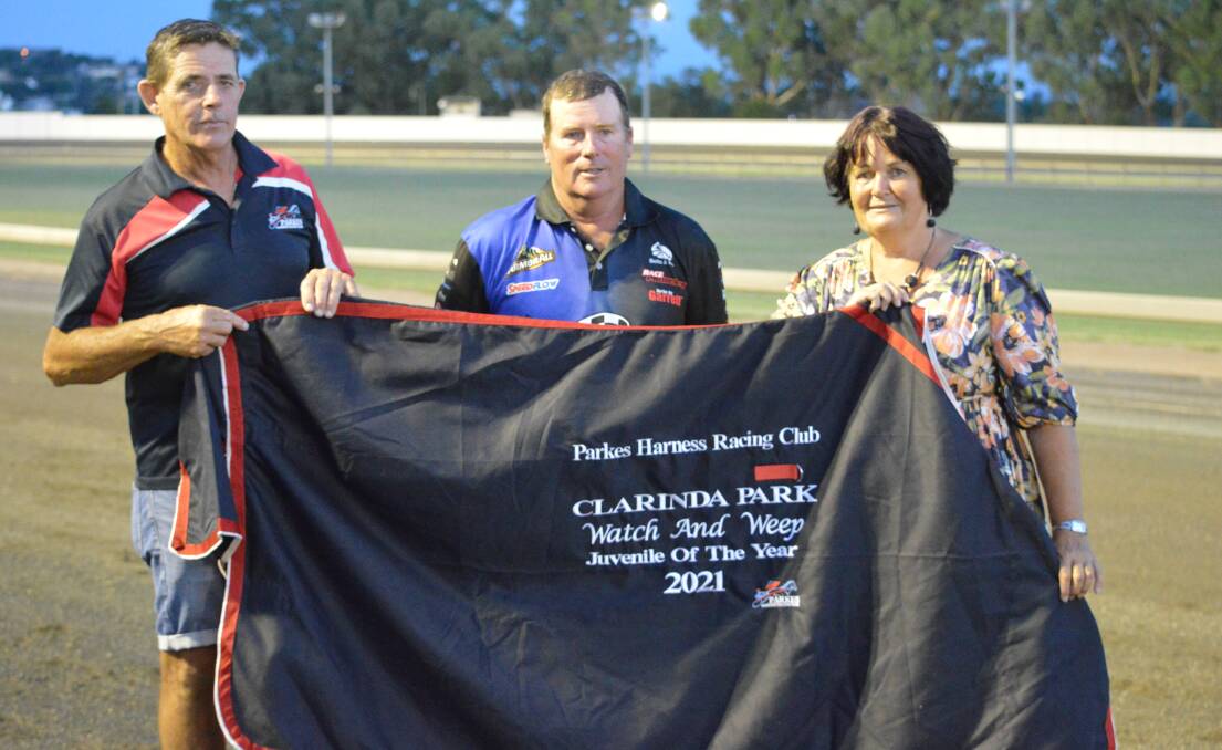 TOP EFFORT: Parkes Harness Racing Club meeting coordinator Tony Dumesny presents the award for Leading Juvenile (Watch and Weep) to trainer Malcolm Hutchings and his wife Daphne. Photo: KRISTY WILLIAMS.