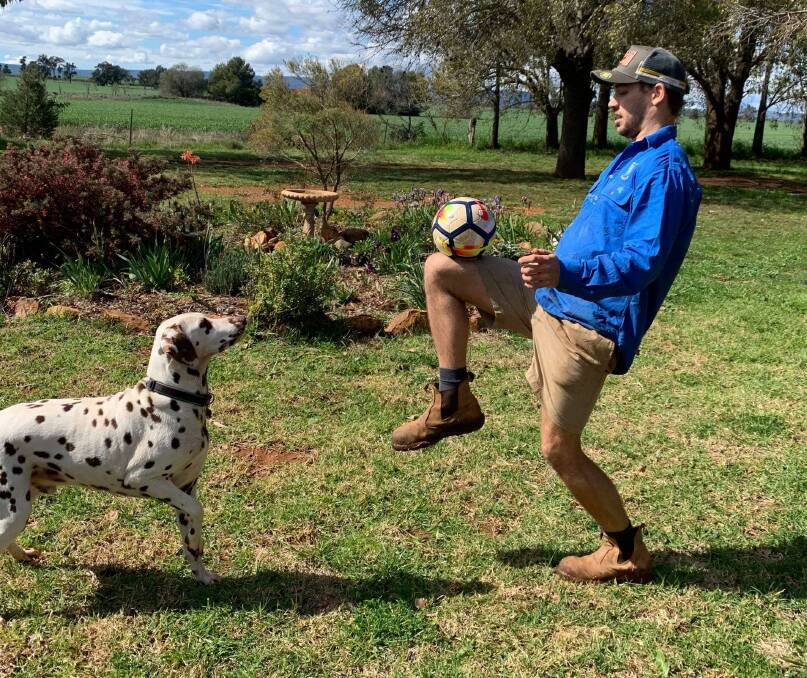 SERIOUS SKILLS: Parkes Cobras defender Hayden Westcott keeps his juggling skills up on his family's farm with the help of his Dalmatian. Photo: SUPPLIED.