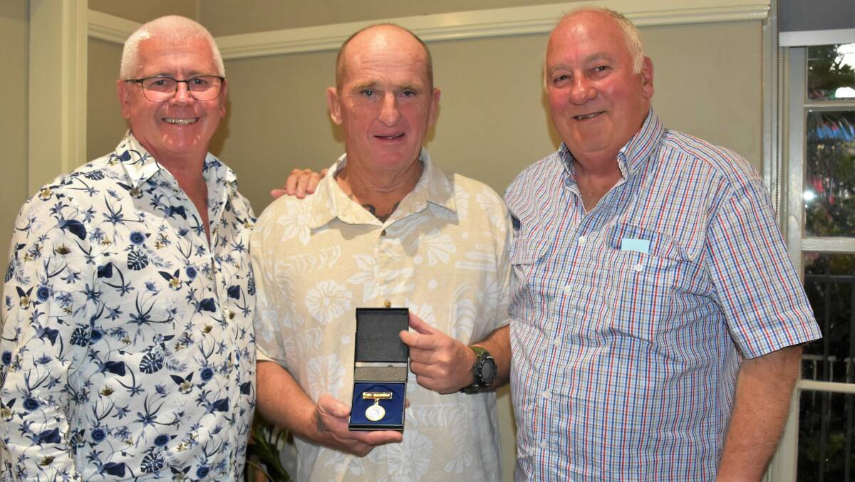 WHAT AN HONOUR: Tony Dwyer (left) and Warwick Wheeldon (right) present Paul Clyburn (centre) with his badge. Photo: JENNY KINGHAM.