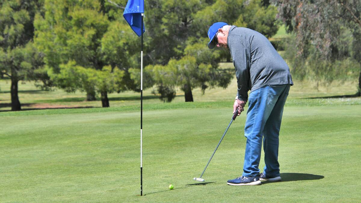  SILVERSIDE: Ian Phipps sinks a putt at the Parkes Golf Club. He was the lucky raffle winner last week. Photo: JENNY KINGHAM.