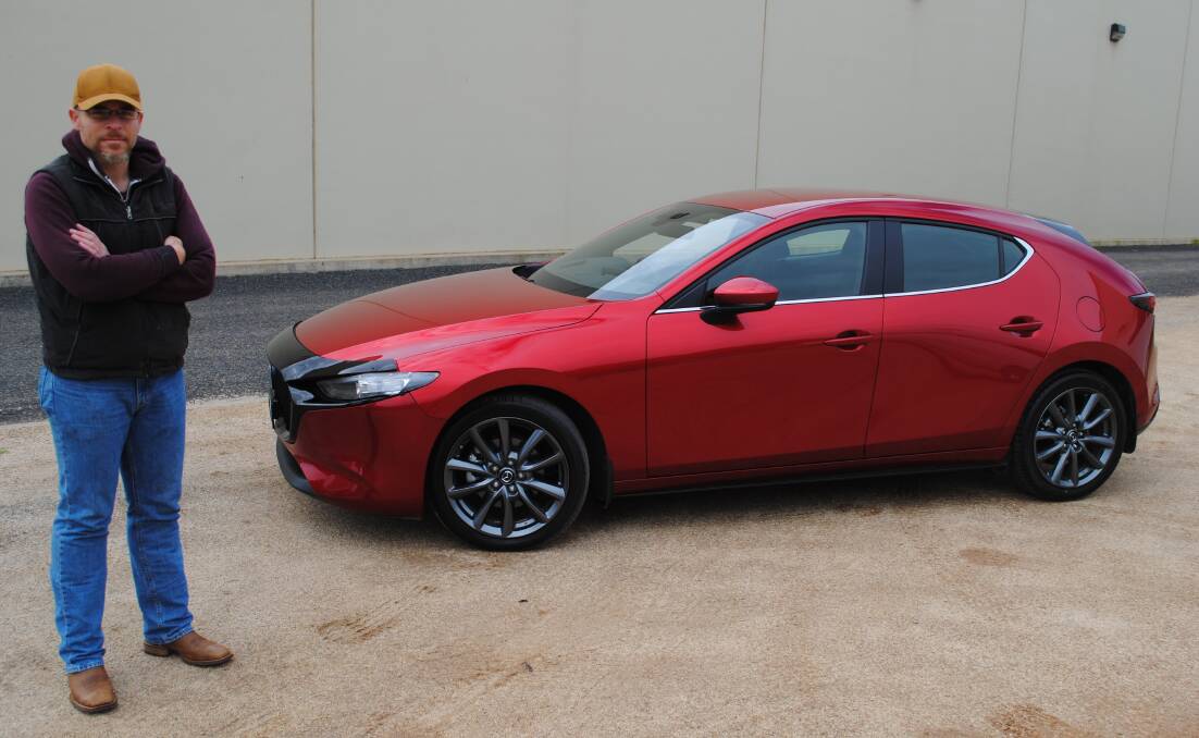 SMOOTH RIDE: Central West Car Club member Richard Eggleston and his 2021 Mazda 3 G25 Evolve hatchback, which is in an eye-catching Soul Red colour. Photo: SUPPLIED. 