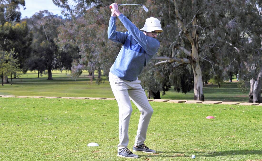 HOT IRON: Jack Matthews has a hit at the Parkes Golf Club. Only a few brave souls put their handicaps on the line in Saturday's poor weather. Photo: JENNY KINGHAM.
