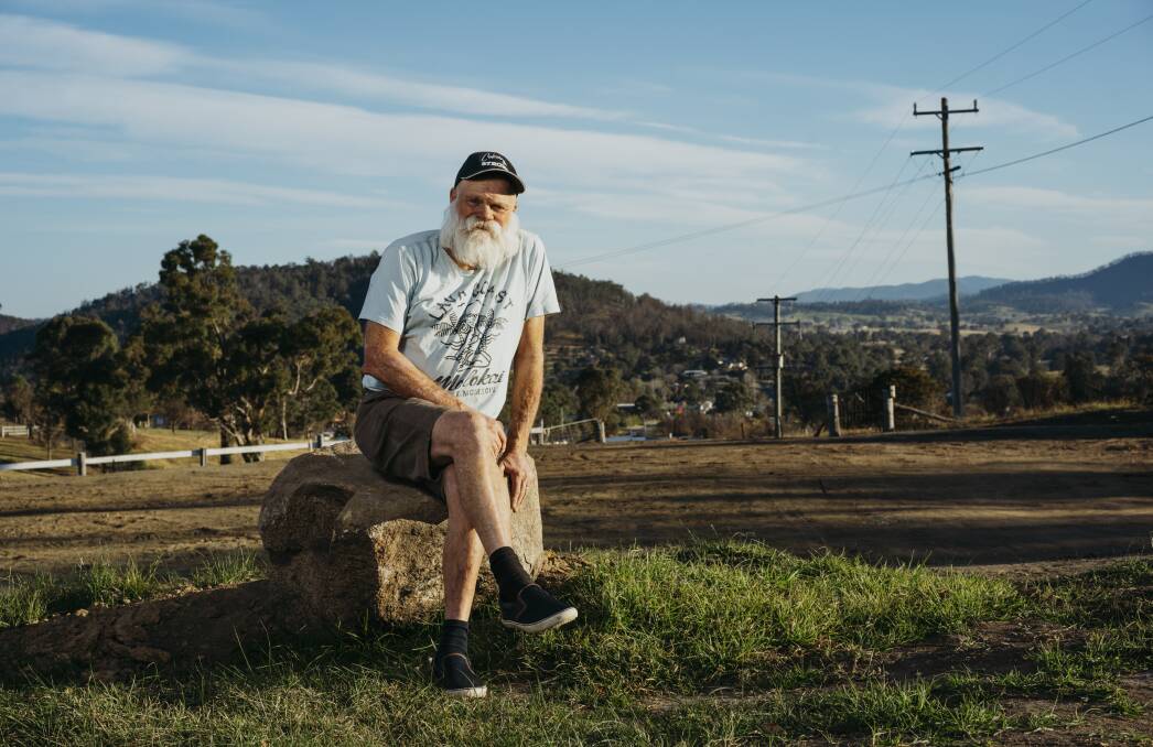 Dave Rugendyke on his cleared plot of land in Cobargo, where his home was destroyed by bushfires at the start of the year. Picture: Dion Georgopoulos 