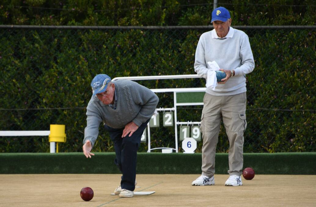 PARKES BOWLS: John Ward (bowling) and Peter McQuie were spotted on the Parkes Bowling and Sports Club greens during drier times last month. Photo: Jenny Kingham