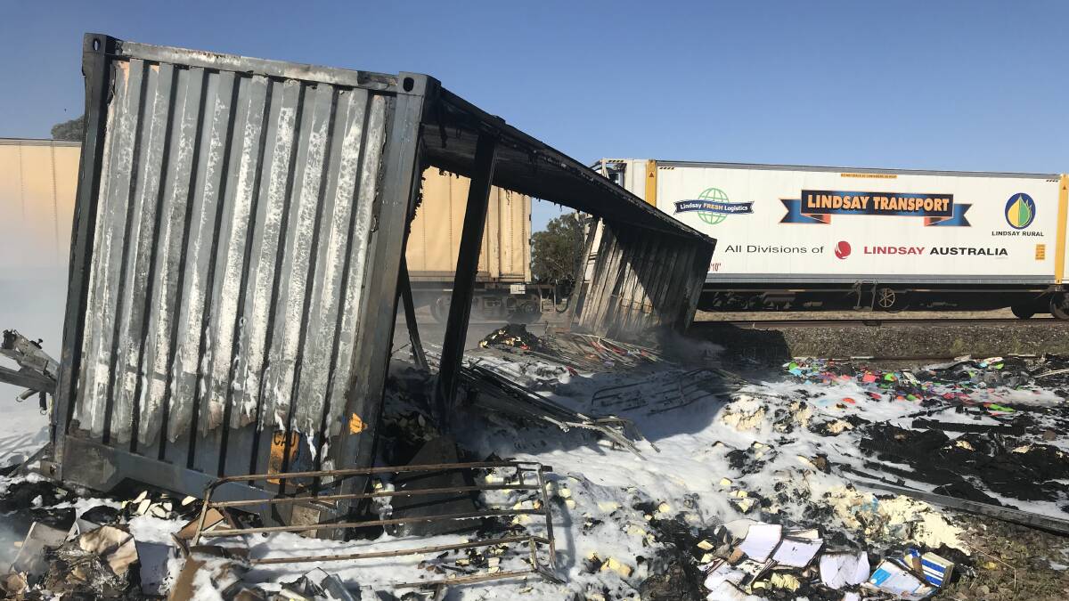 COLLISION: A container was dislodged and sparked a paddock fire following a collision between a truck and freight train at the level crossing on the Mary Gilmore Way near Bribbaree on Tuesday morning. Photo: contributed