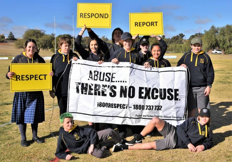FORBES: Lily Walsh, Dustin Bond, Biana Lincoln, Tom Boyd, Xander Williams, Janssen Mores, Kule Ryan, John Darcy. Lying down - Beau Dukes-Rankmore and Xander Williams supporting White Ribbon's message at last year's footy match. Photo: Jenny Kingham