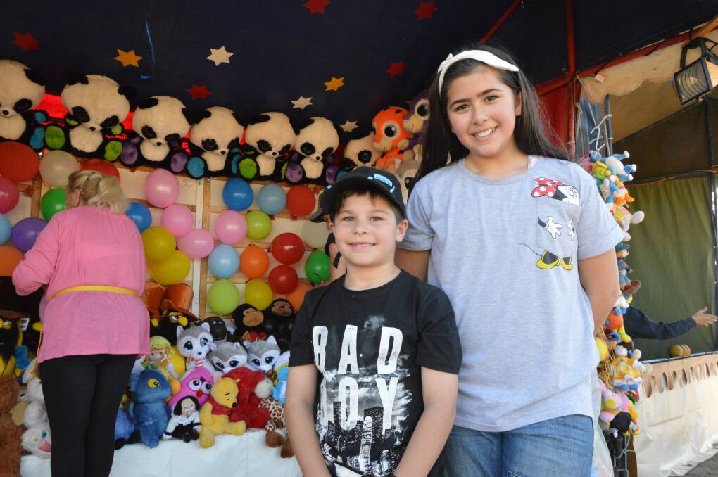 Testing their skills: Eight-year-old Riley Pizzi and nine-year-old Isabella Elias, tried their luck to win a prize at one of the many sideshow alley games. Photos: Christine Little.