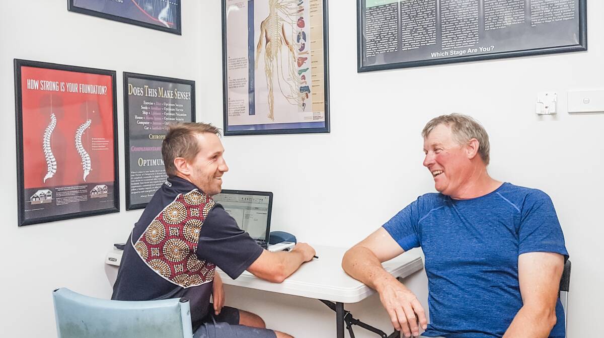 Helping hands: Chiropractic Life's Dr Bernie Haberman discusses the treatment options available with Mr Mark Hodges. Photo: Supplied.