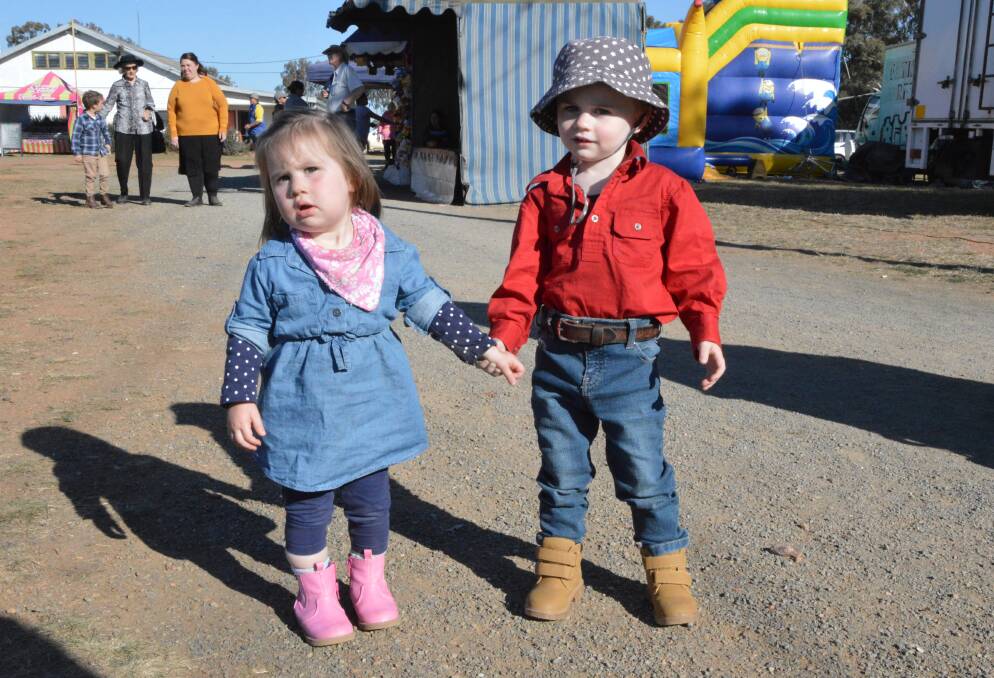 Ready for some fun: Ruby Stanford and Hugo Breust, both of Peak Hill, hand-in-hand at the 2017 Peak Hill Show. Photo: Christine Little.