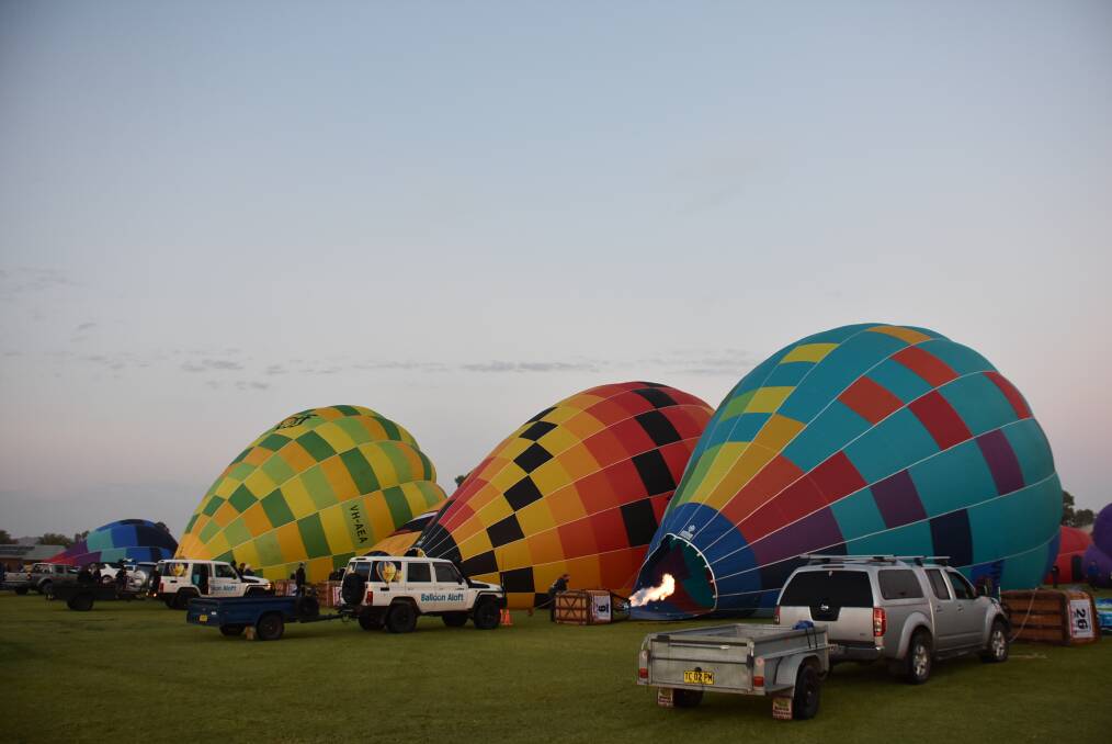 Ready for lift off: Crews begin to inflate their balloons ahead of the days events. Photo: File.
