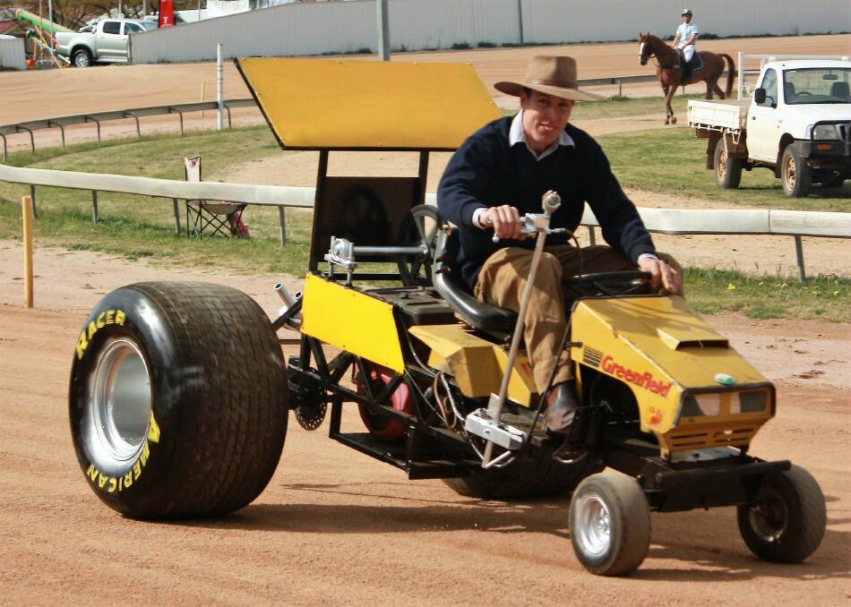 Roaring to life: Past Parkes Show Society president Garry O'Brien, take a racing mower for a spin in preparation for the lawn mower races. Photo: Supplied.