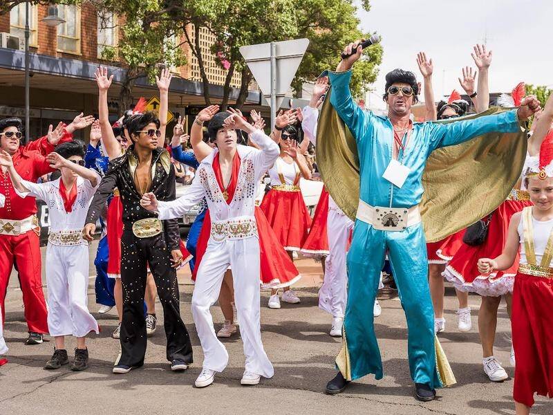 Dooley Thomson (aqua jumpsuit) from Parkes participates in the street parade every year and brings with him a cohort of Elvis fans. The Parkes Elvis Festival will in January celebrate its 30th anniversary. Picture supplied